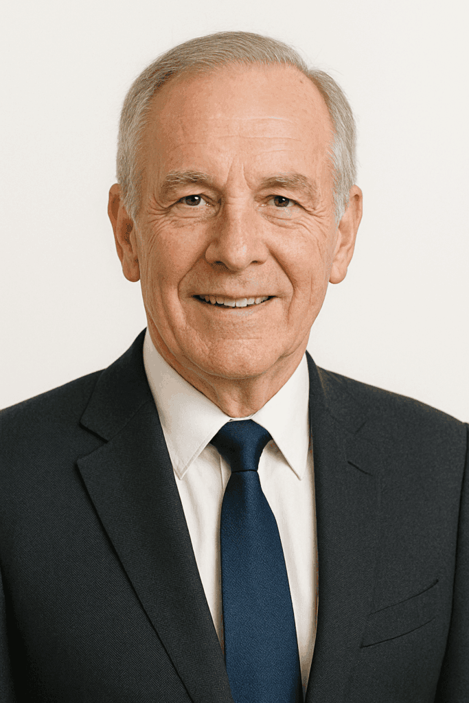 "Portrait photo of Howard S. wearing a dark suit jacket, standing confidently with arms crossed, Real Estate Agent from Surrey who completed the course while working full-time"